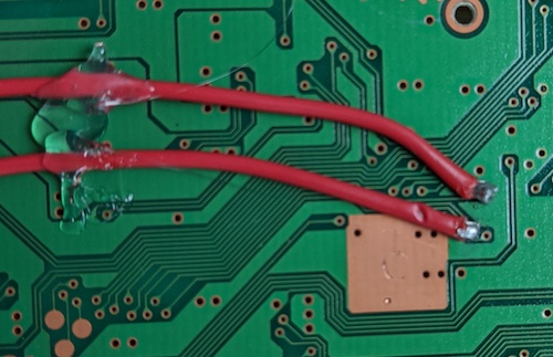 The first two solder points on the back of the board